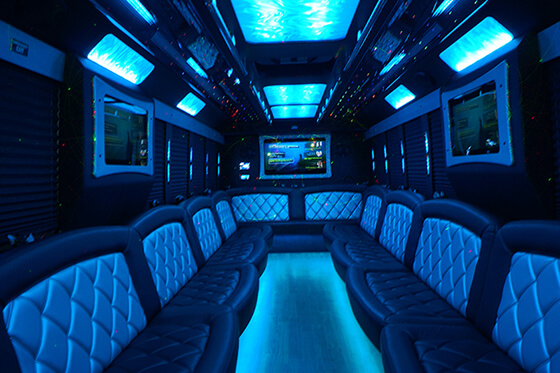 party bus interior with leather seats and flat screen TVs