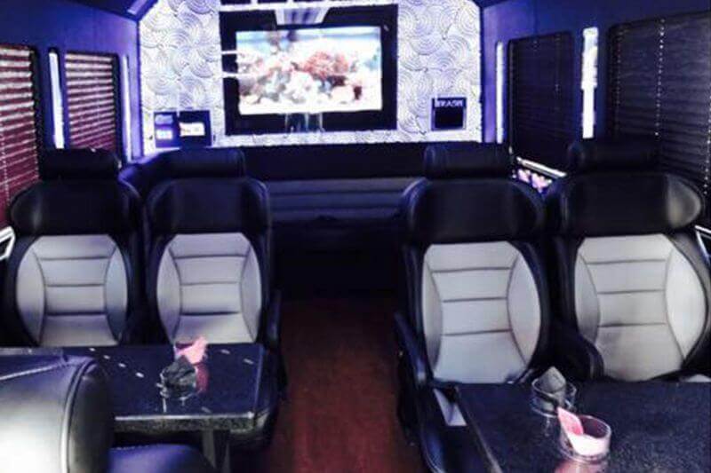 party bus interior with leather seats and flat screen TVs